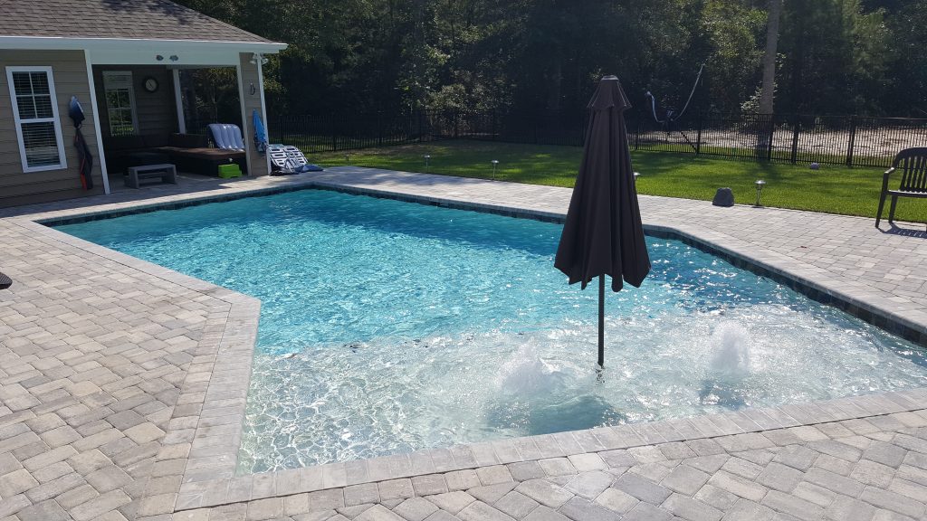 myrtle beach pool builder contractor myrtle beach swimming pool spa travertine waterfall water feature fountain blue pool sun shelf custom