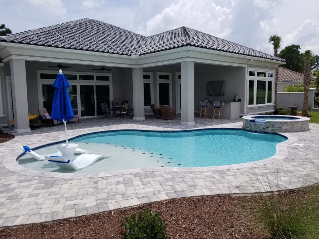 myrtle beach pool builder contractor myrtle beach swimming pool spa travertine waterfall water feature fountain blue pool sun shelf custom