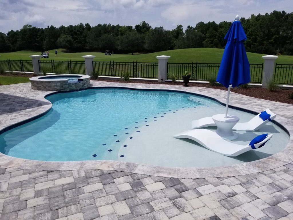 myrtle beach pool builder contractor myrtle beach swimming pool spa travertine waterfall water feature fountain blue pool sun shelf custom