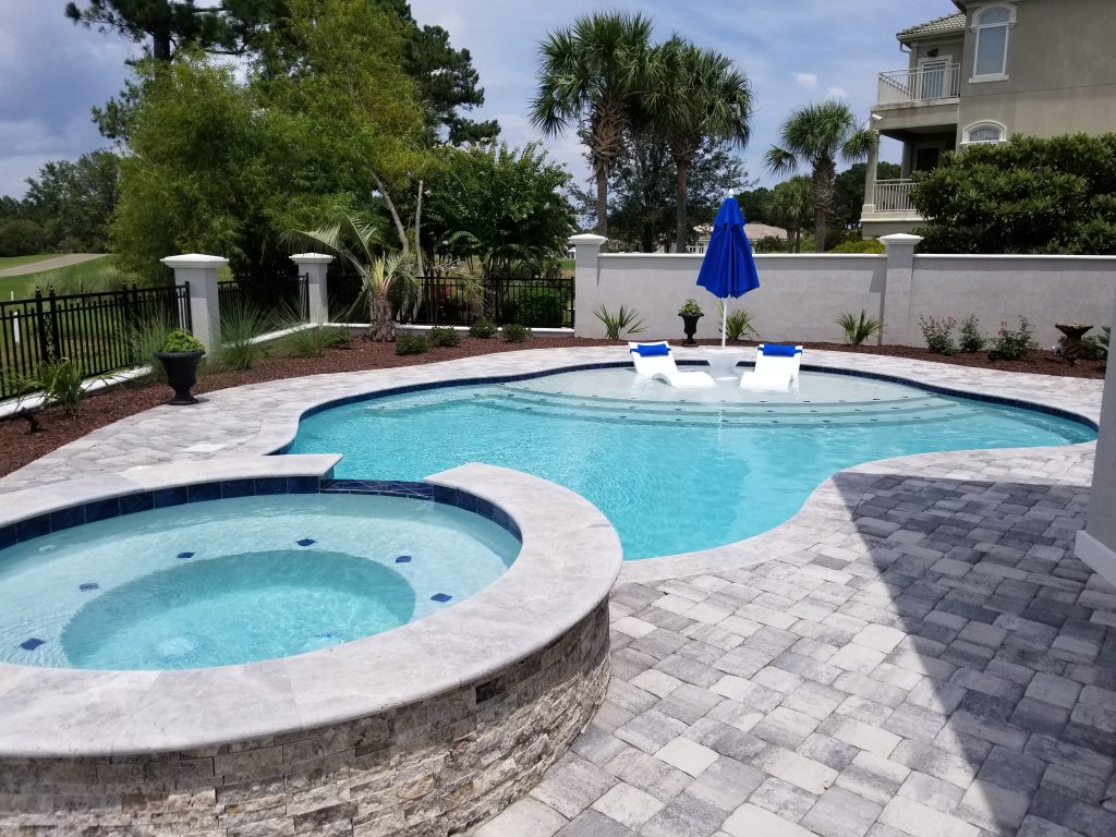 myrtle beach pool builder contractor myrtle beach swimming pool spa travertine waterfall water feature fountain blue pool sun shelf custom