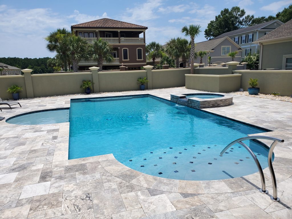 myrtle beach pool builder contractor myrtle beach swimming pool spa travertine waterfall water feature fountain blue pool sun shelf custom