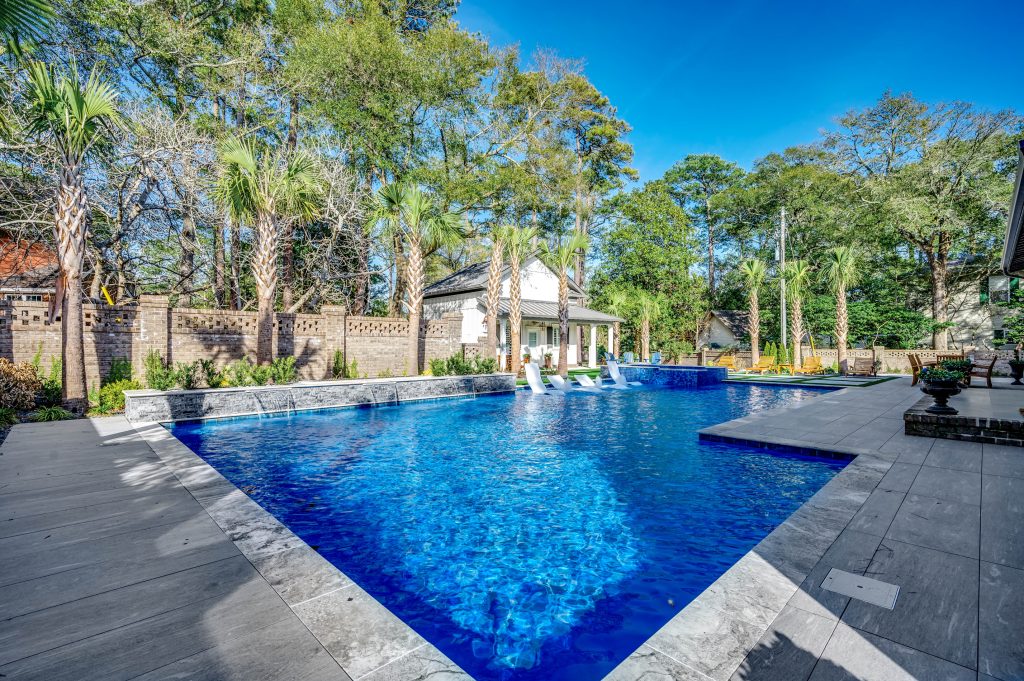 myrtle beach pool builder contractor myrtle beach swimming pool spa travertine waterfall water feature fountain blue pool sun shelf custom