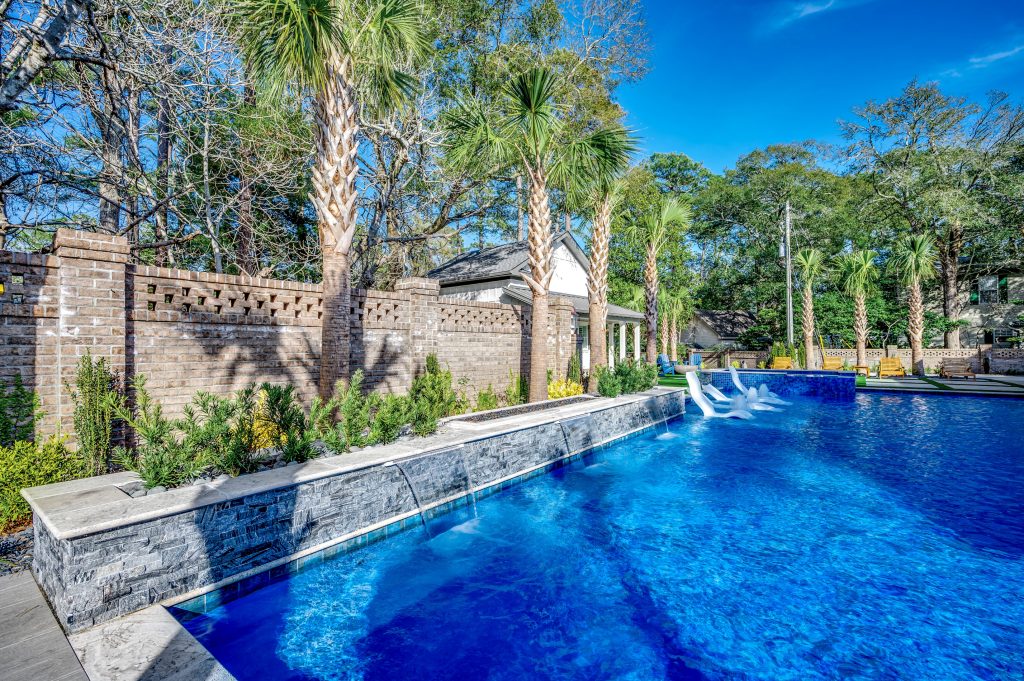 myrtle beach pool builder contractor myrtle beach swimming pool spa travertine waterfall water feature fountain blue pool sun shelf custom