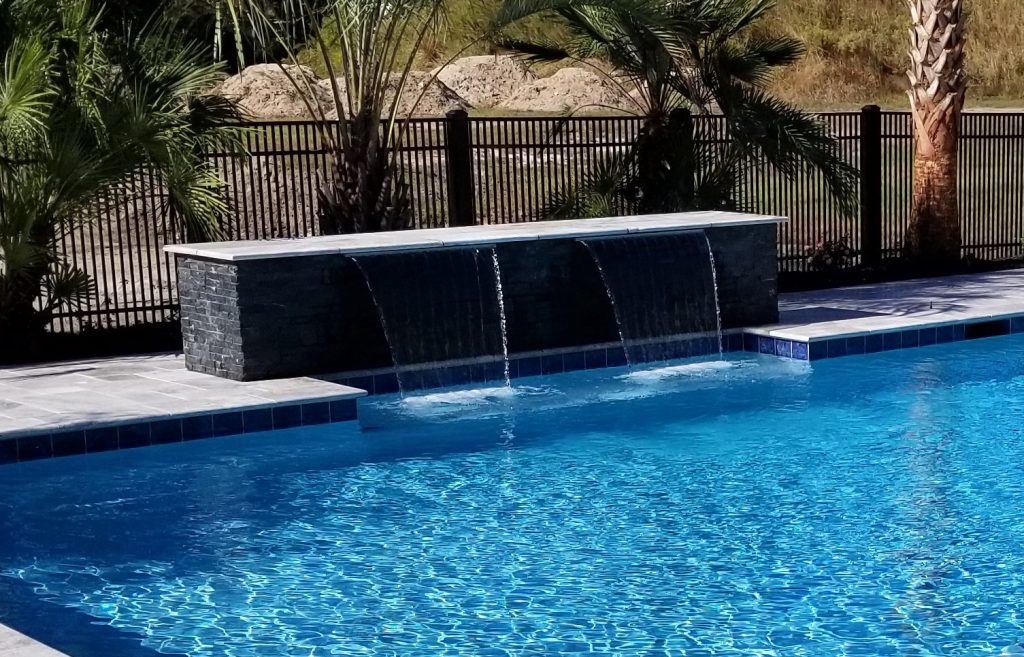 myrtle beach pool builder contractor myrtle beach swimming pool spa travertine waterfall water feature fountain blue pool sun shelf custom